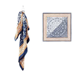 Retro navy blue and beige paisley pattern silk square scarf shown flat and hanging.