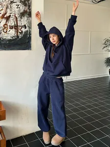Close-up showing the fit of navy blue oversized hoodie and matching wide-leg sweatpants