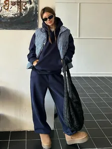 Full-body lifestyle shot showing the fit of a navy blue retro oversized tracksuit