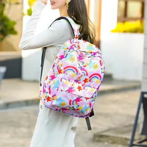 Lifestyle view of a colorful backpack with star and rainbow patterns worn by a girl outdoors