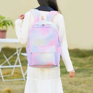 Girl wearing a dreamy pastel gradient backpack with pink and blue starry sky pattern