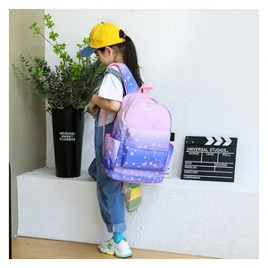 A young girl wearing a gradient purple starry sky printed backpack in a bright lifestyle setting