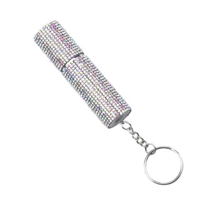 Detail view of a portable rhinestone-encrusted perfume atomizer bottle with a keychain