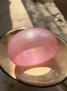 Macro detail of pink iridescent chunky resin bangle with Y2K dopamine aesthetic vibe