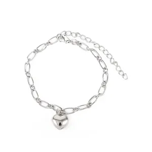 Detailed view of minimalist silver-colored bracelet with polished heart pendant
