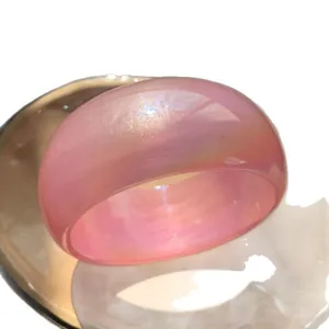 Chunky pearlescent pink resin bangle with iridescent shimmer for Y2K style