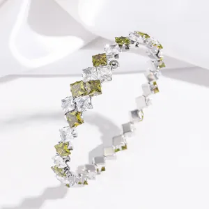 Elegant titanium steel open spring bracelet with green and white square cut zircons.