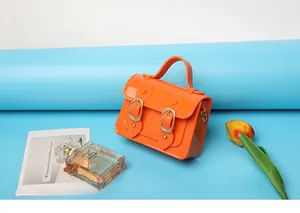 Vibrant orange mini jelly Cambridge satchel bag featuring decorative buckle details