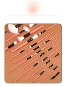 Detailed close-up view of 24-piece pink makeup brush set with synthetic bristles