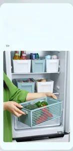 Detail view of the hollow plastic storage basket with handles for refrigerator use.