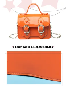 Close-up detail of orange jelly Cambridge satchel with smooth finish and chain strap