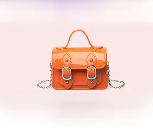 Bright orange mini jelly Cambridge satchel bag featuring a gold chain strap and handle
