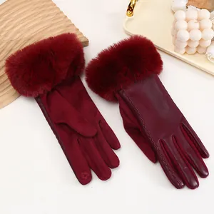 Detail of burgundy women's winter gloves with plush faux fur cuffs and PU leather splicing