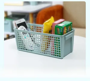 Detail of light blue mesh storage basket containing snacks and remote control