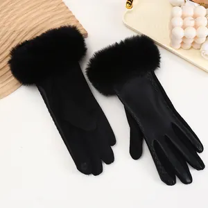 Detail view of black suede and PU leather winter gloves with plush faux fur cuffs.
