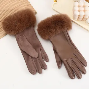 Detail of brown winter gloves with faux fur trim and suede leather patchwork