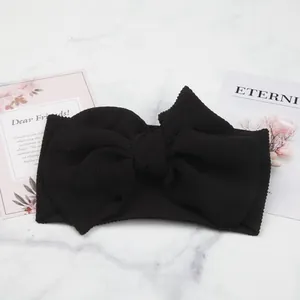 Close-up of black bubble textured baby headband featuring a large decorative bow