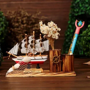 Close-up detail of Mediterranean wooden sailing ship desktop ornament with dual pen holders.