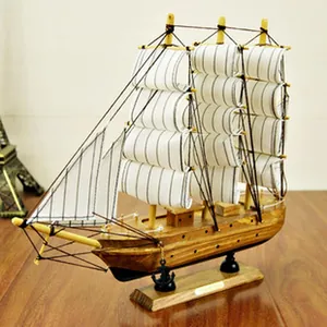 Detailed handcrafted Mediterranean wooden sailboat model with white striped sails ornament