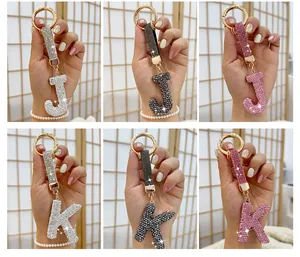 Multiple sparkling rhinestone letter J and K keychains in silver black and pink colors