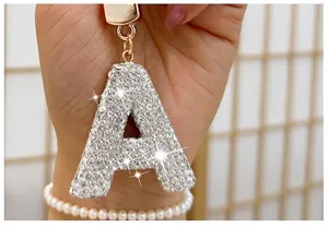 Detailed close-up view of a silver-tone letter A keychain encrusted with sparkling rhinestones
