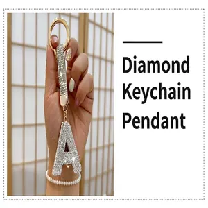 Detailed view of rhinestone-encrusted letter A keychain with golden hardware