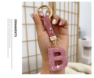Macro detail of a sparkling pink rhinestone letter B keychain for bags and cars