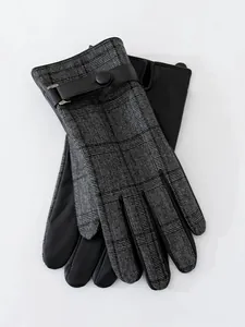 Detail view of men's winter gloves featuring classic plaid wool and black leather finish