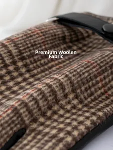 Macro detail of the high-quality brown plaid woolen fabric on winter thermal gloves