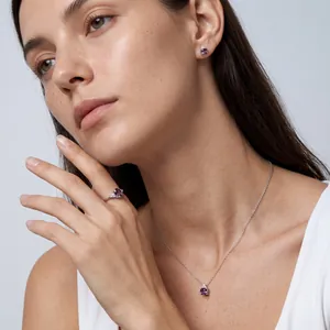 Elegant sterling silver jewelry set featuring oval purple alexandrite stones on model