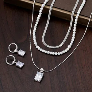 Elegant jewelry set featuring a layered necklace and rectangular zircon hoop earrings