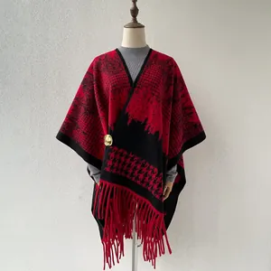 Close-up detail of British style red and black houndstooth pattern shawl with fringe