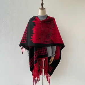 Detail view of British style houndstooth shawl with elegant red and black tassel fringe.