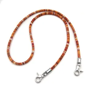 Close-up of colorful woven replacement shoulder strap with silver lobster clasps