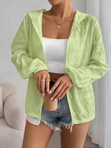 Detailed view of women's lime green textured sun-protection hooded jacket with zipper