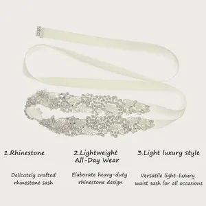 Elegant bridal rhinestone sash with white ribbon and intricate leaf-patterned crystal beads