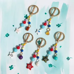 Detailed macro view of colorful beaded keychains featuring unique celestial star charms