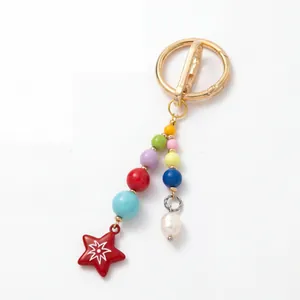 Close-up of colorful beaded keychain featuring a red star charm and white pearl