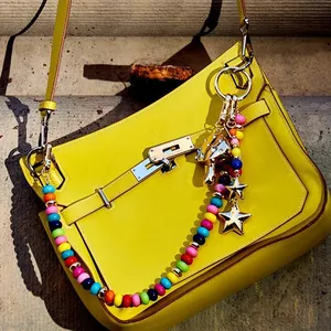 Vibrant multi-colored beaded bag charm featuring gold mushroom and star pendants for handbags