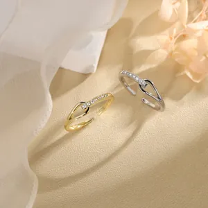 Macro view of minimalist interlocking rings with sparkling pavé-set zircons on textured surface