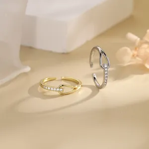 Detail of minimalist interlocking knotted rings with cubic zirconia pavé accents
