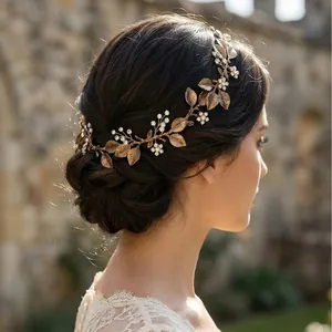 Elegant vintage bridal headband with gold leaves, handmade flowers, and pearls.