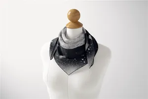 Close-up of black and white silk square scarf with celestial star pattern on mannequin