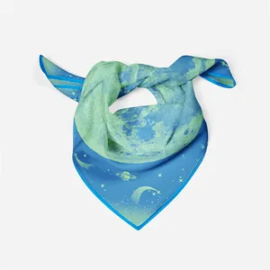 Detailed close-up of a stylish blue and lime green silk square scarf with celestial moon prints