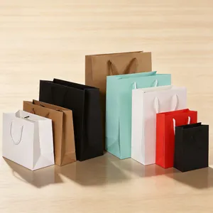 Assorted sizes of colorful kraft paper gift bags with durable handles for retail shopping