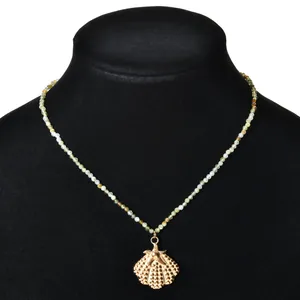 Vintage ethnic style necklace with natural stone beads and a gold shell starfish pendant