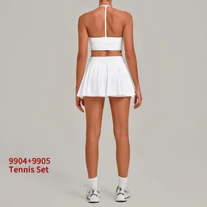 Back view of white two-piece tennis set with sports bra and pleated skirt