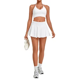 White two-piece tennis set with halter sports bra and pleated athletic skirt for yoga