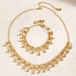 Elegant gold-plated tassel necklace and bracelet set featuring sparkling zircon crystals.