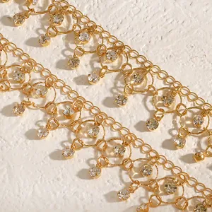 Detailed view of elegant gold-plated choker with dangling clear rhinestones and geometric links.